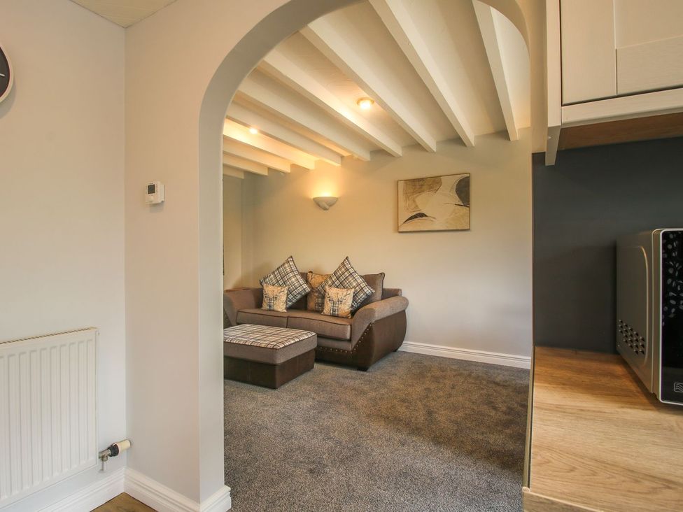 A living room with a sofa and decorative pillows at 1 Clarkes Lane in St Martins