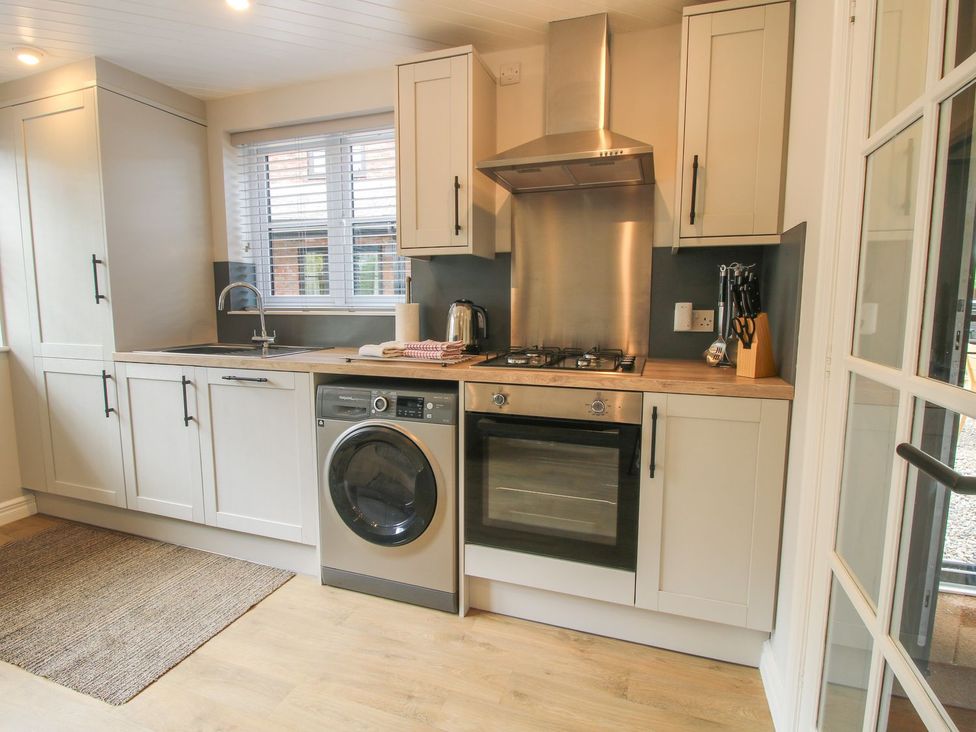 A kitchen with appliances and cabinets at 1 Clarkes Lane St Martins
