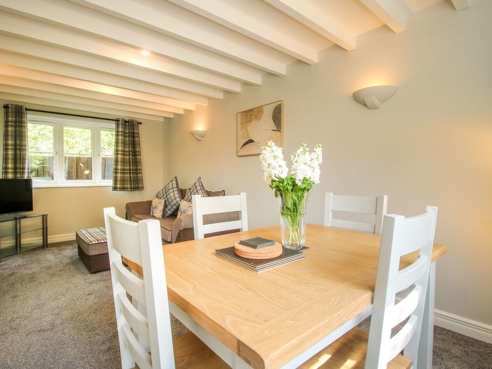 A living room with a table and chairs at 1 Clarkes Lane in St Martins