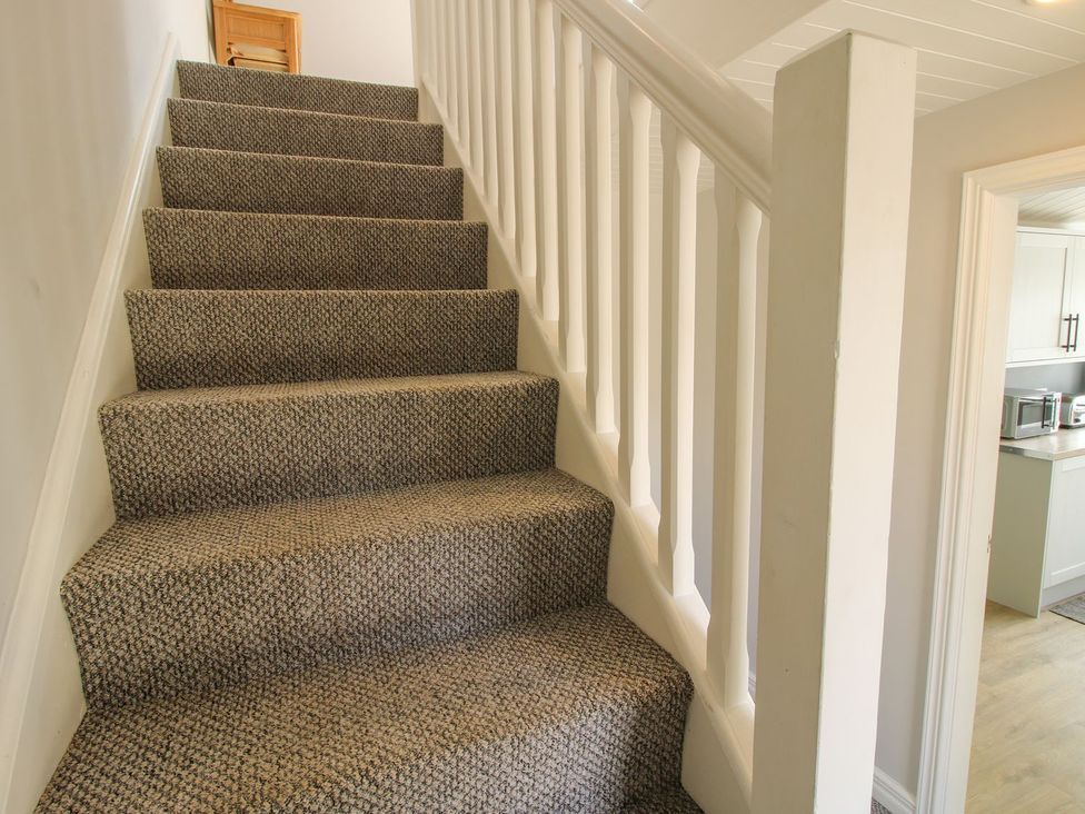 Stairs with carpet and handrail leading to an upper level at 1 Clarkes Lane St Martins