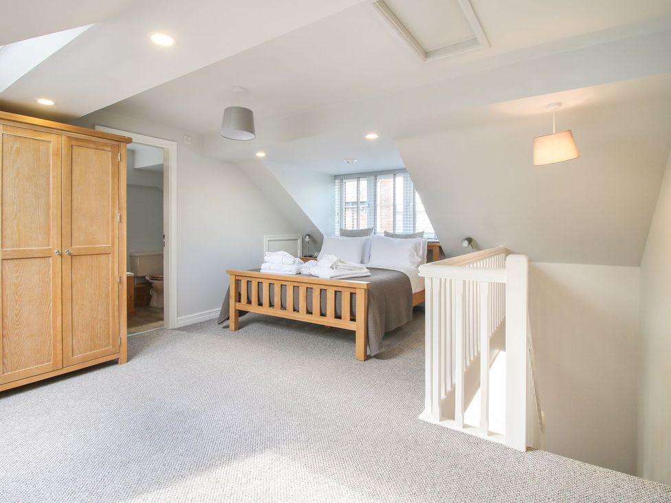 A bedroom with a bed and wardrobe at 1 Clarkes Lane St Martins