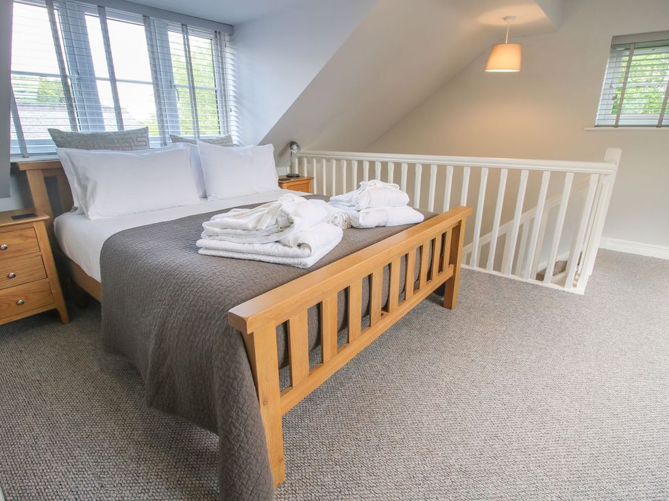 A bedroom with a bed and bedside table at 1 Clarkes Lane in St Martins