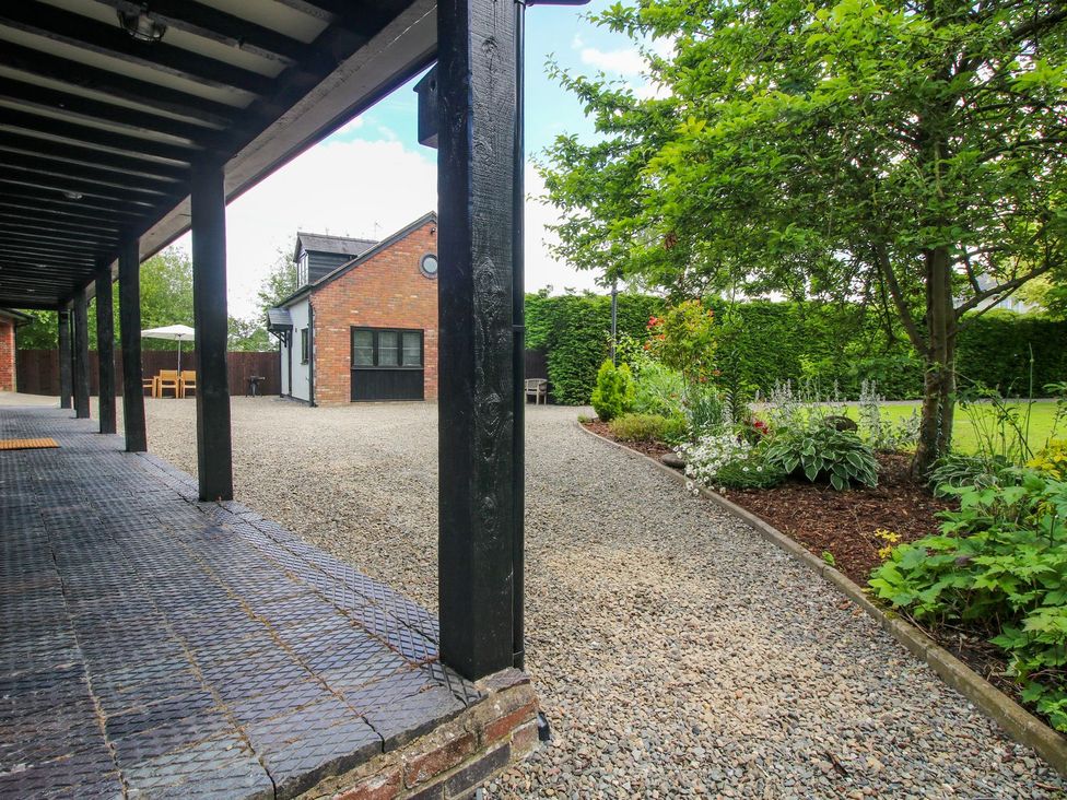 A garden with a gravel pathway and seating area at 1 Clarkes Lane St Martins