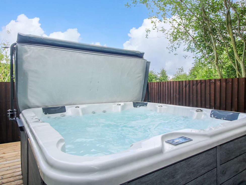A hot tub with water in an outdoor setting at 1 Clarkes Lane St Martins