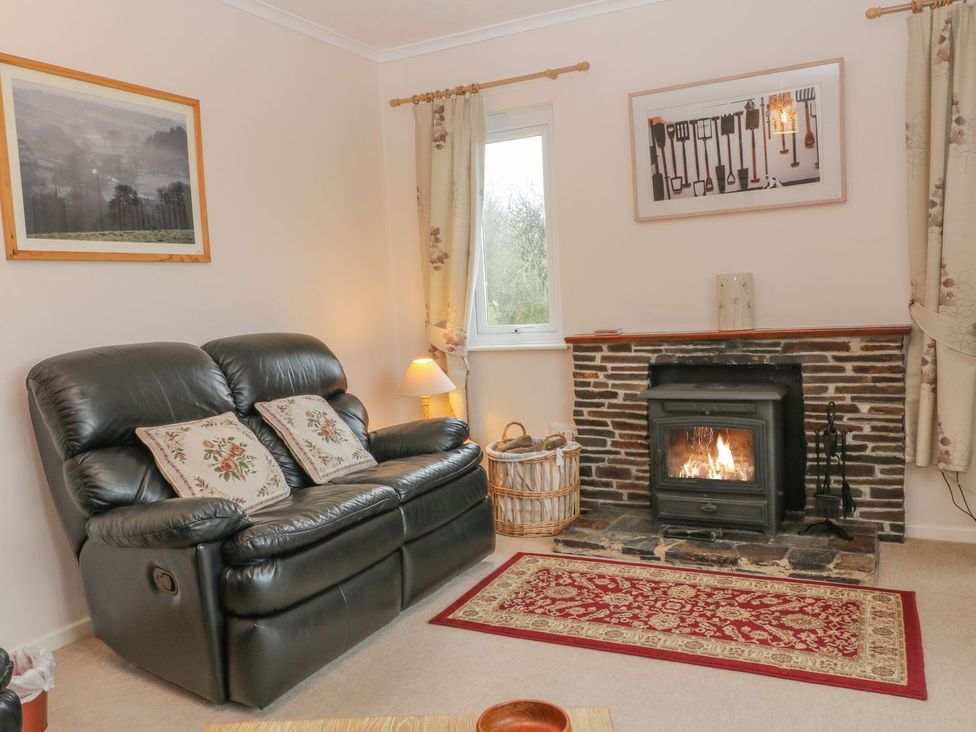 A living room with a sofa and a fireplace at Orchard End in Launceston