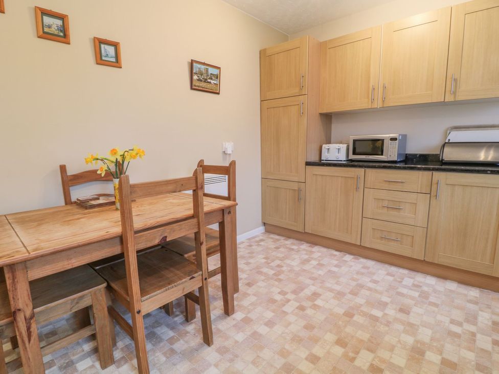 A kitchen with a dining table and chairs at Orchard End in Launceston