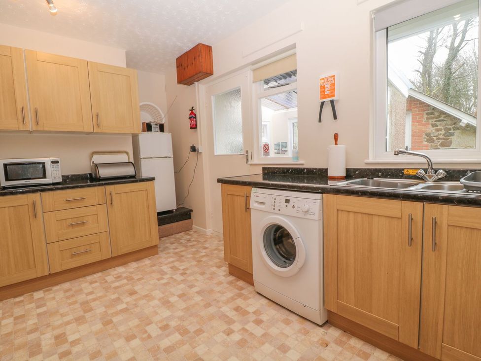 A kitchen with cabinets and appliances at Orchard End in Launceston