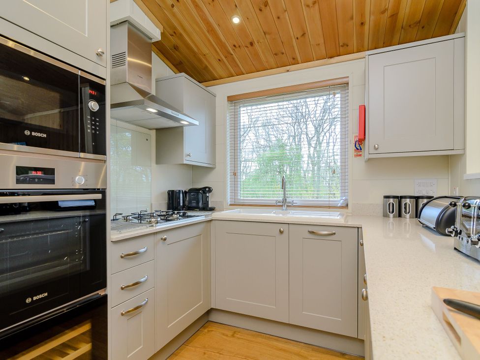 A kitchen with appliances and a window at The Sutton (Pet) in Kings Cliffe