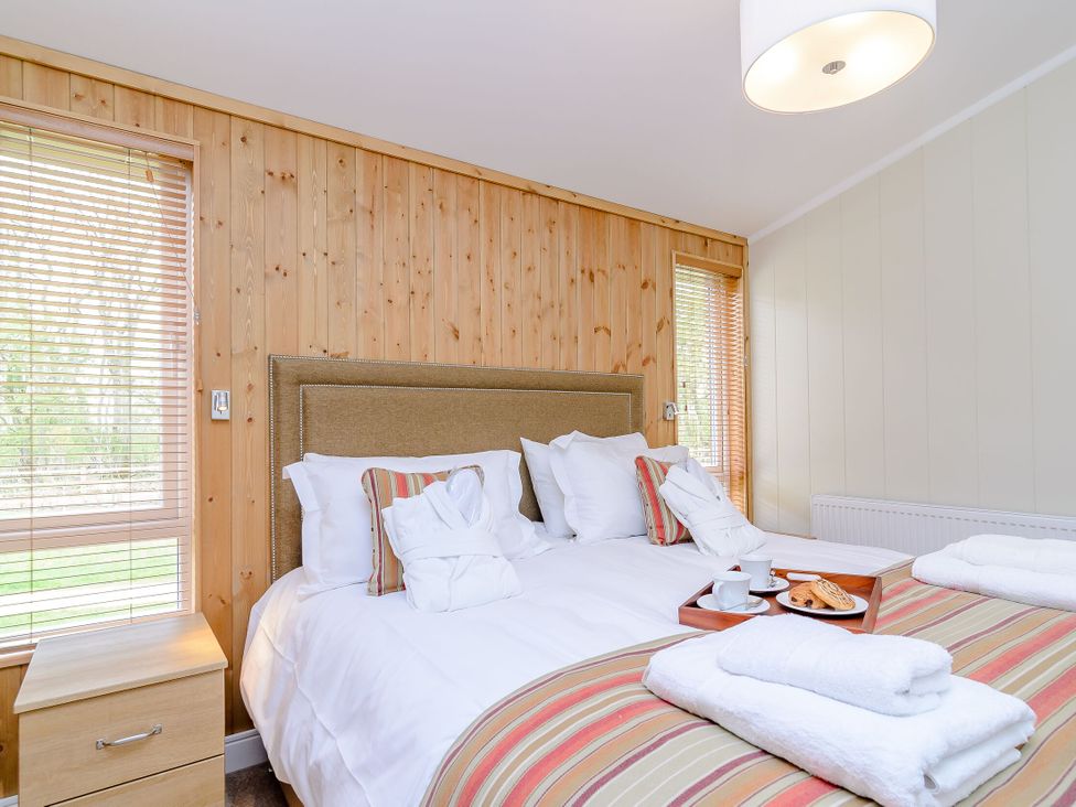 A bedroom with a bed and bedside table at The Sutton (Pet) Kings Cliffe