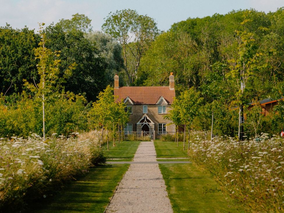 A house with pathway and trees at The Sutton (Pet) in Kings Cliffe