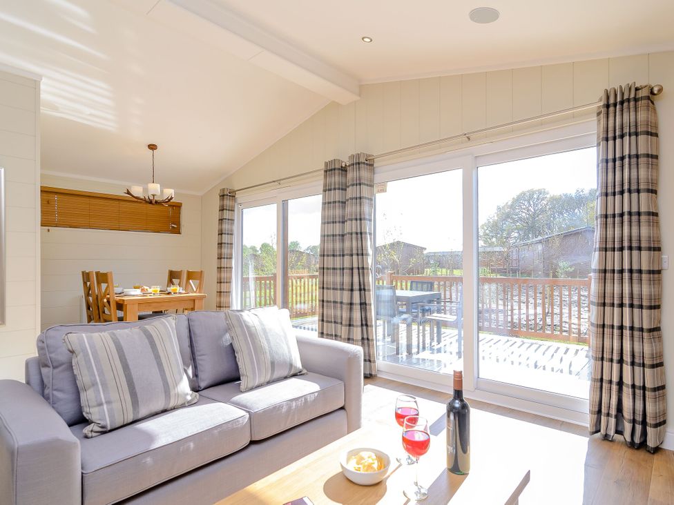 A living room with a sofa and dining area at The Chesterton in Kings Cliffe