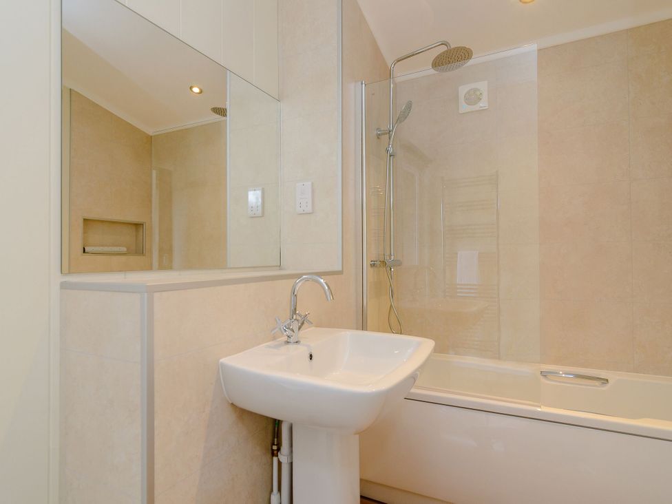A bathroom featuring a sink, bathtub, and shower at The Chesterton (Pet) Kings Cliffe