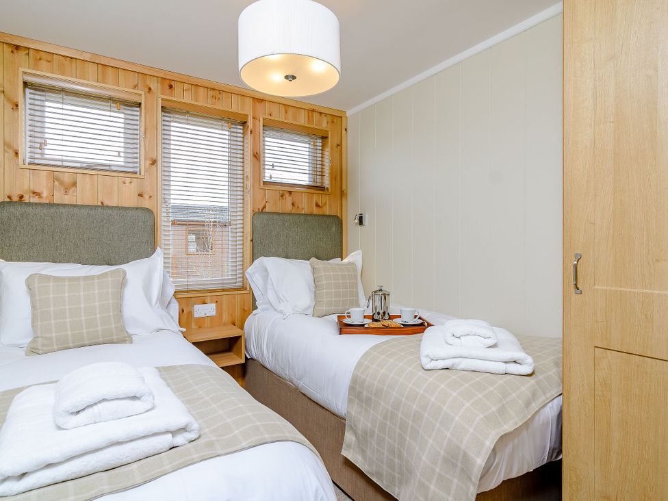 A bedroom with two beds and a tray with tea at The Nassington (Pet) Kings Cliffe