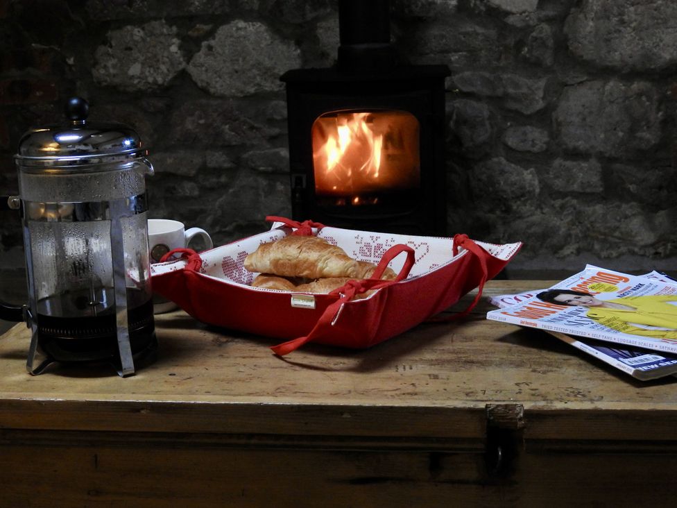 A dining room with a coffee maker and croissant on a tray at Ramsgrove in Swansea