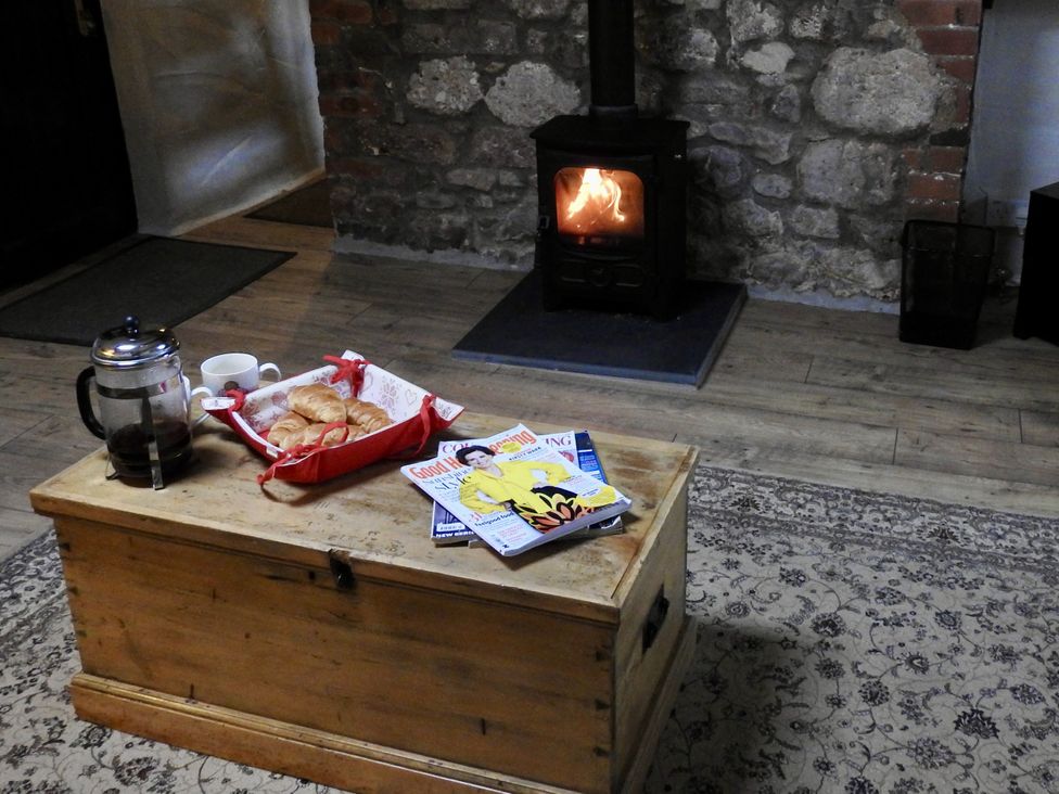 A living room with a wooden chest and magazines at Ramsgrove in Swansea