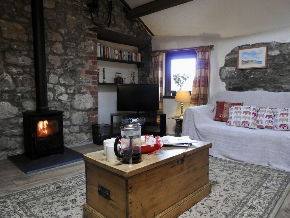 A living room with a fireplace and sofa at Ramsgrove in Swansea