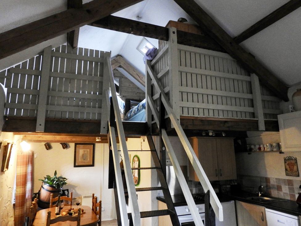 A kitchen with staircase leading to a loft at Ramsgrove in Swansea