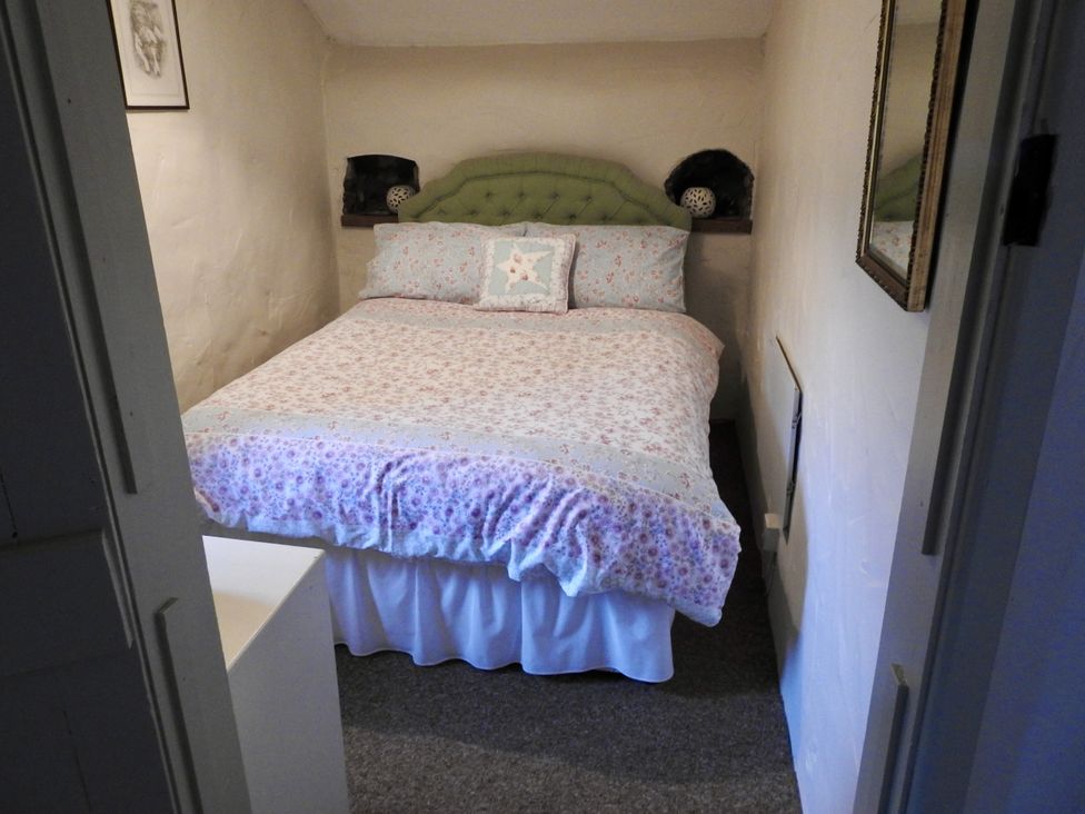 A bedroom with a bed and a small table at Ramsgrove in Swansea