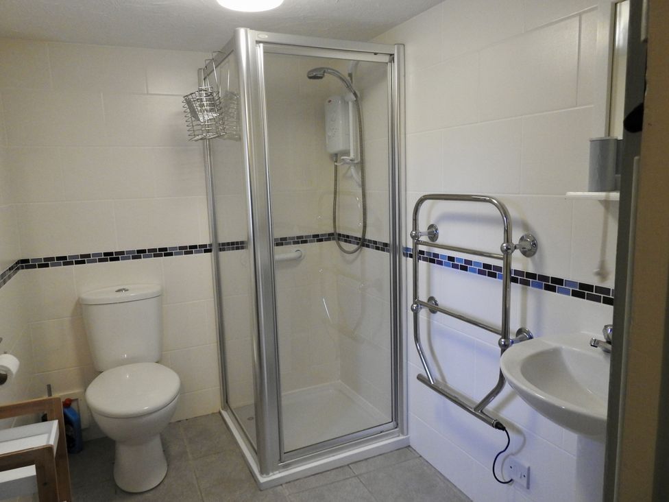 A bathroom with a shower and toilet at Ramsgrove in Swansea