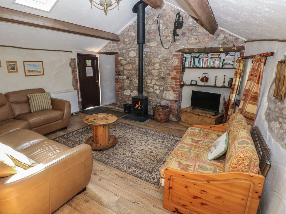 A living room with a sofa and a fireplace at Ramsgrove in Pilton