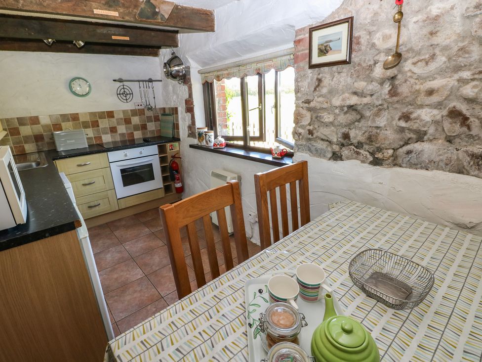 A kitchen with wooden table and chairs at Ramsgrove in Pilton