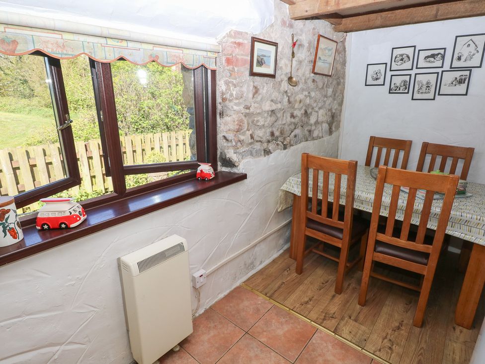 A dining room with a table and wooden chairs at Ramsgrove in Pilton