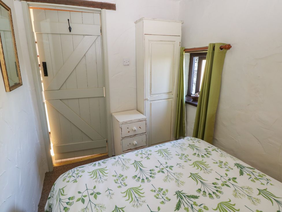 A bedroom with a bed and wardrobe at Ramsgrove in Pilton