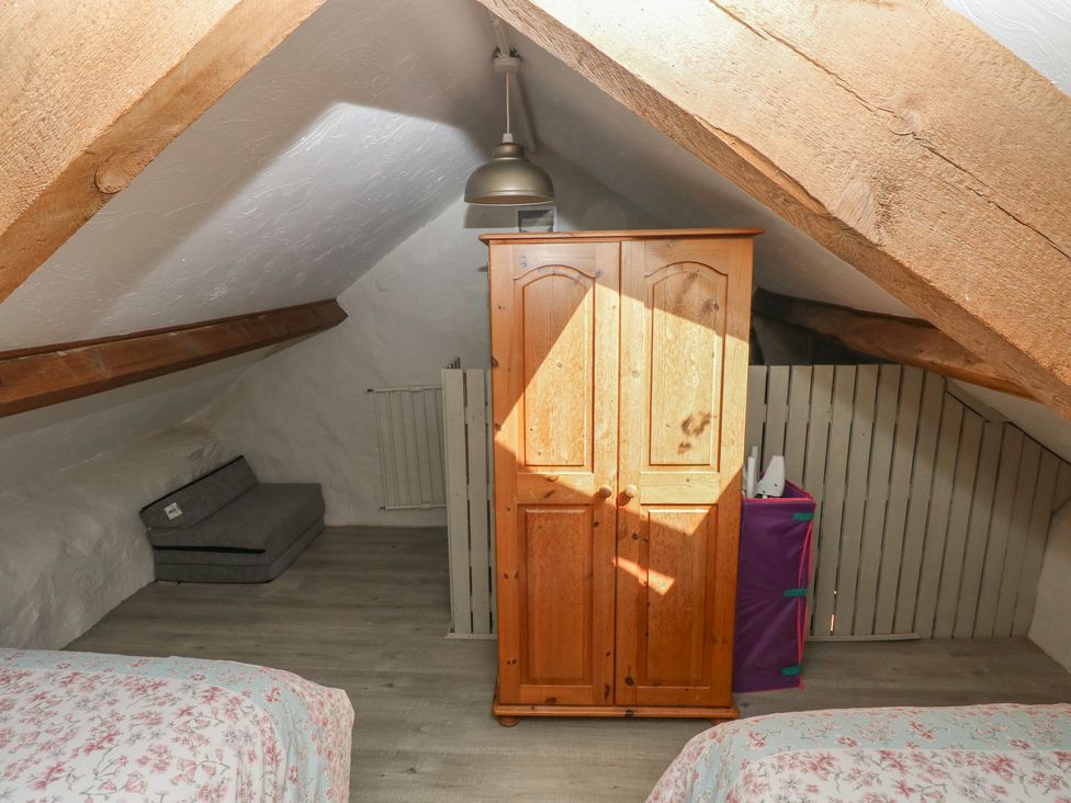A bedroom with a wardrobe and a sofa at Ramsgrove in Pilton