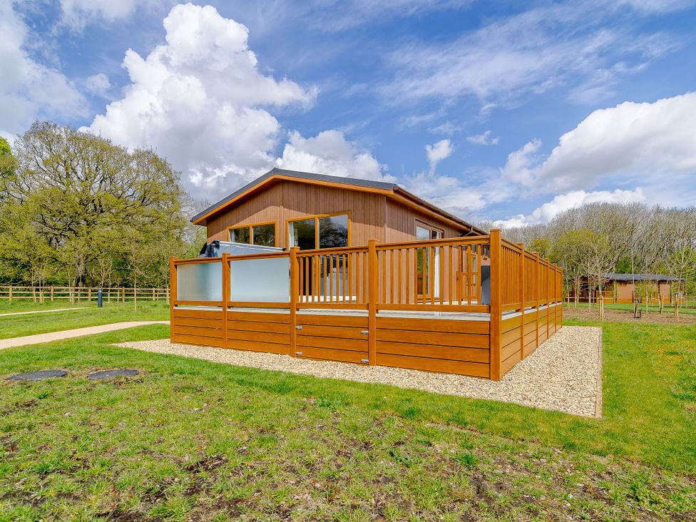 A house with a deck and grass area at The Yarwell in Kings Cliffe