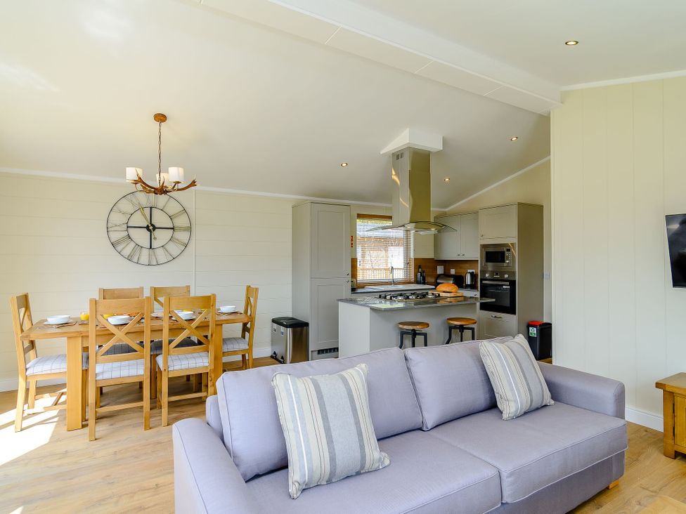 A living room with a sofa and dining area at The Yarwell in Kings Cliffe