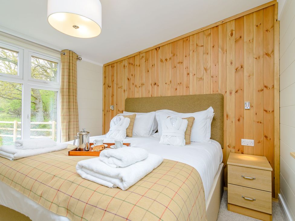 A bedroom with a bed and nightstand at The Wansford in Kings Cliffe
