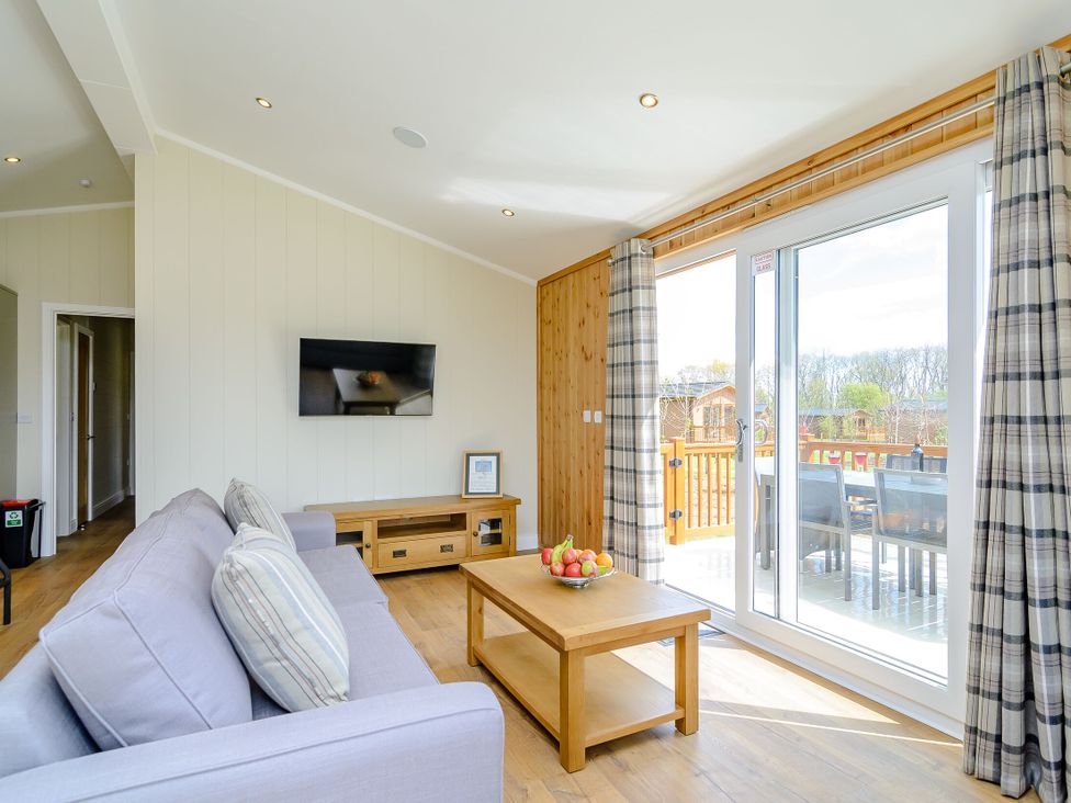 A living room with a sofa and television at The Yarwell (Pet) in Kings Cliffe