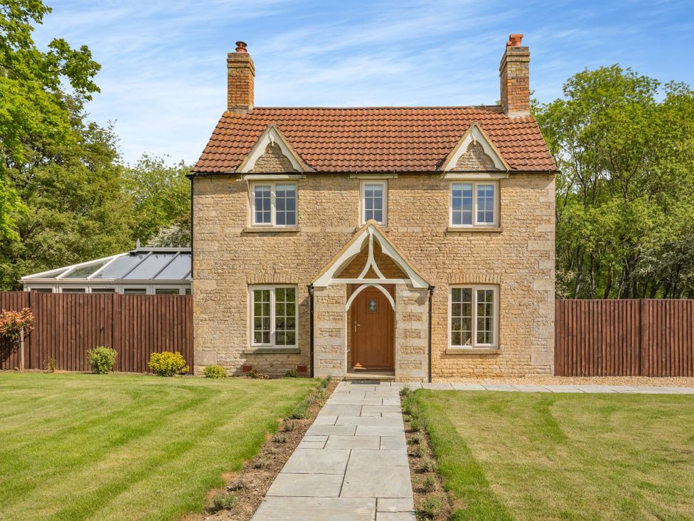 A house with a pathway and garden at The Cottage in Kings Cliffe
