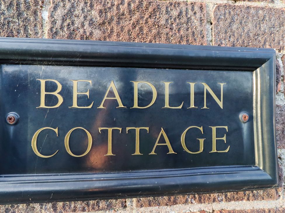 A plaque with the words Beadlin Cottage at Beadlin cottage Beadnell