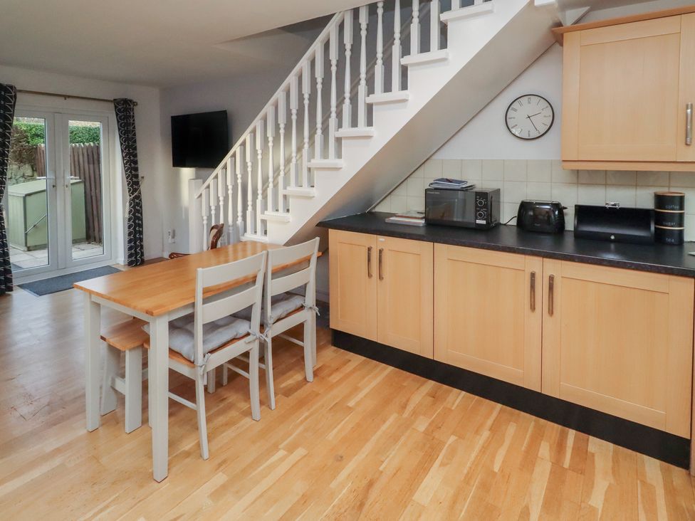 A kitchen with a table and chairs at Beadlin cottage in Beadnell