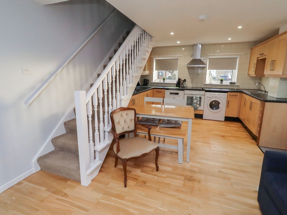 A kitchen with a table and chairs at Beadlin cottage Beadnell