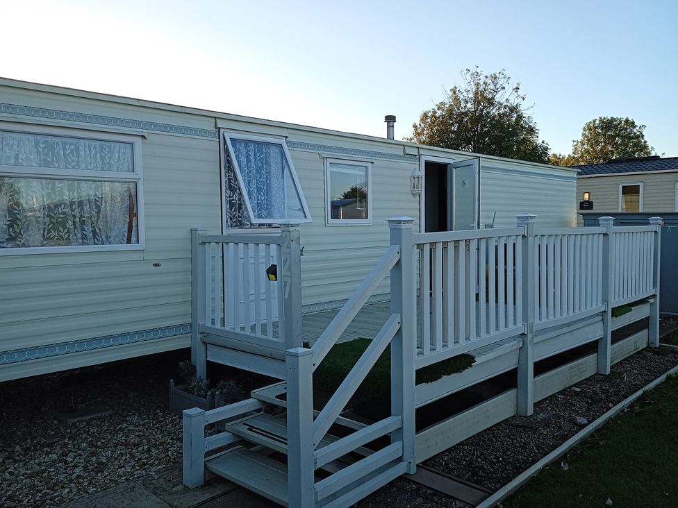 A mobile home with steps and a railing at Atlas Moonstone 