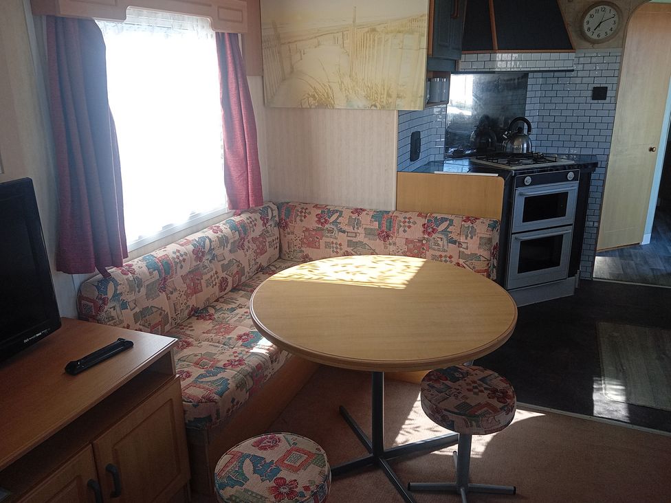 A kitchen with a seating area and appliances at Atlas Moonstone in Ingoldmells