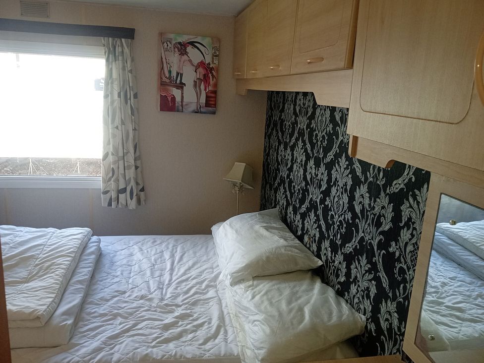 A bedroom with a bed and window at Atlas Moonstone in Ingoldmells