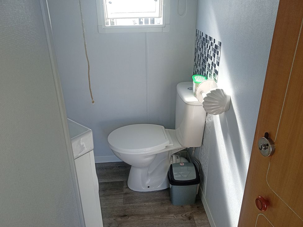 A bathroom with a toilet and sink at Atlas Moonstone in Ingoldmells