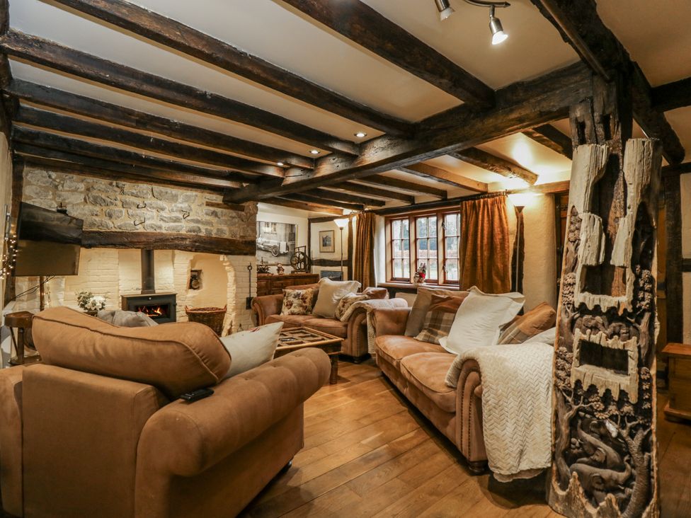 A living room with a sofa, coffee table, and fireplace at 24 Eastcourt