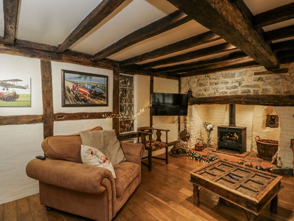 A snug with a sofa, coffee table, and fireplace at 24 Eastcourt