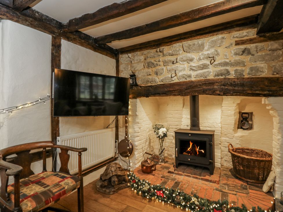 A living room with a fireplace and television at 24 Eastcourt