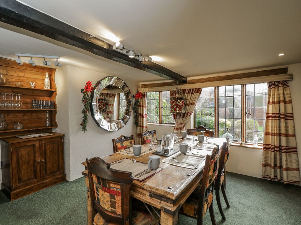 A dining room with a table set and a mirror at 24 Eastcourt in 