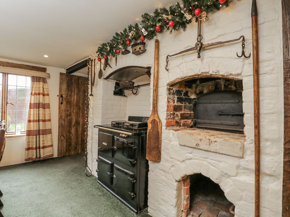 A kitchen with an oven and brick oven at 24 Eastcourt
