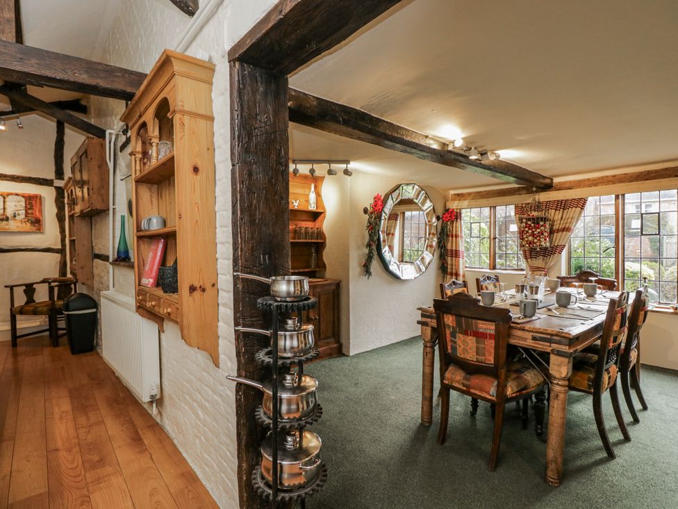 A dining room with a table, chairs, and a mirror at 24 Eastcourt