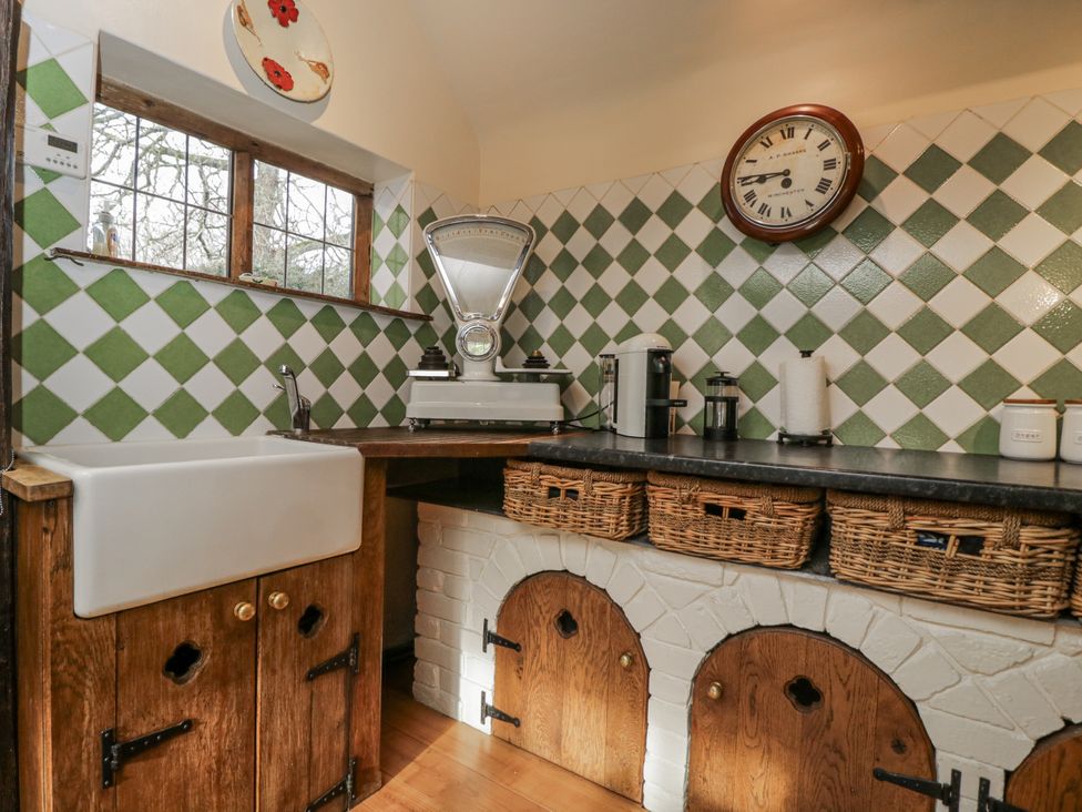A kitchen with a sink and storage baskets at 24 Eastcourt