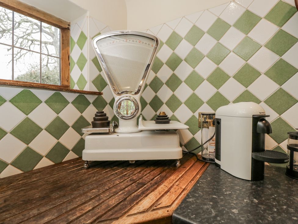 A kitchen with a scale and coffee maker at 24 Eastcourt