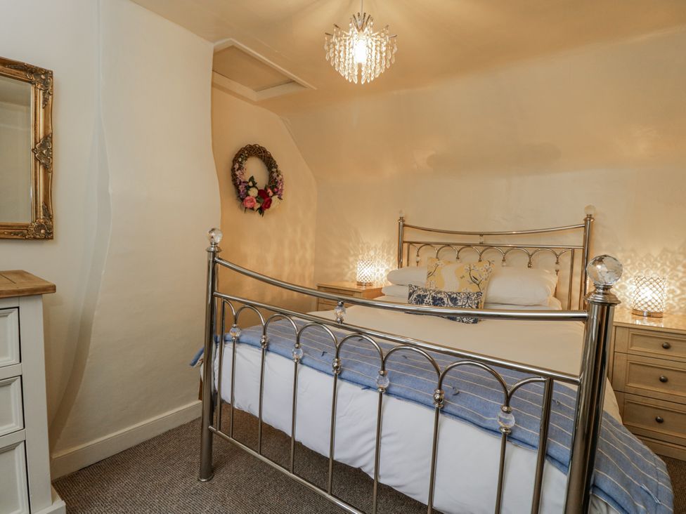 A bedroom with a bed and nightstands at 24 Eastcourt