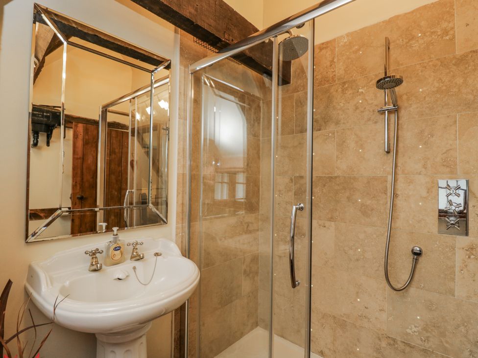 A bathroom with a shower and sink at 24 Eastcourt